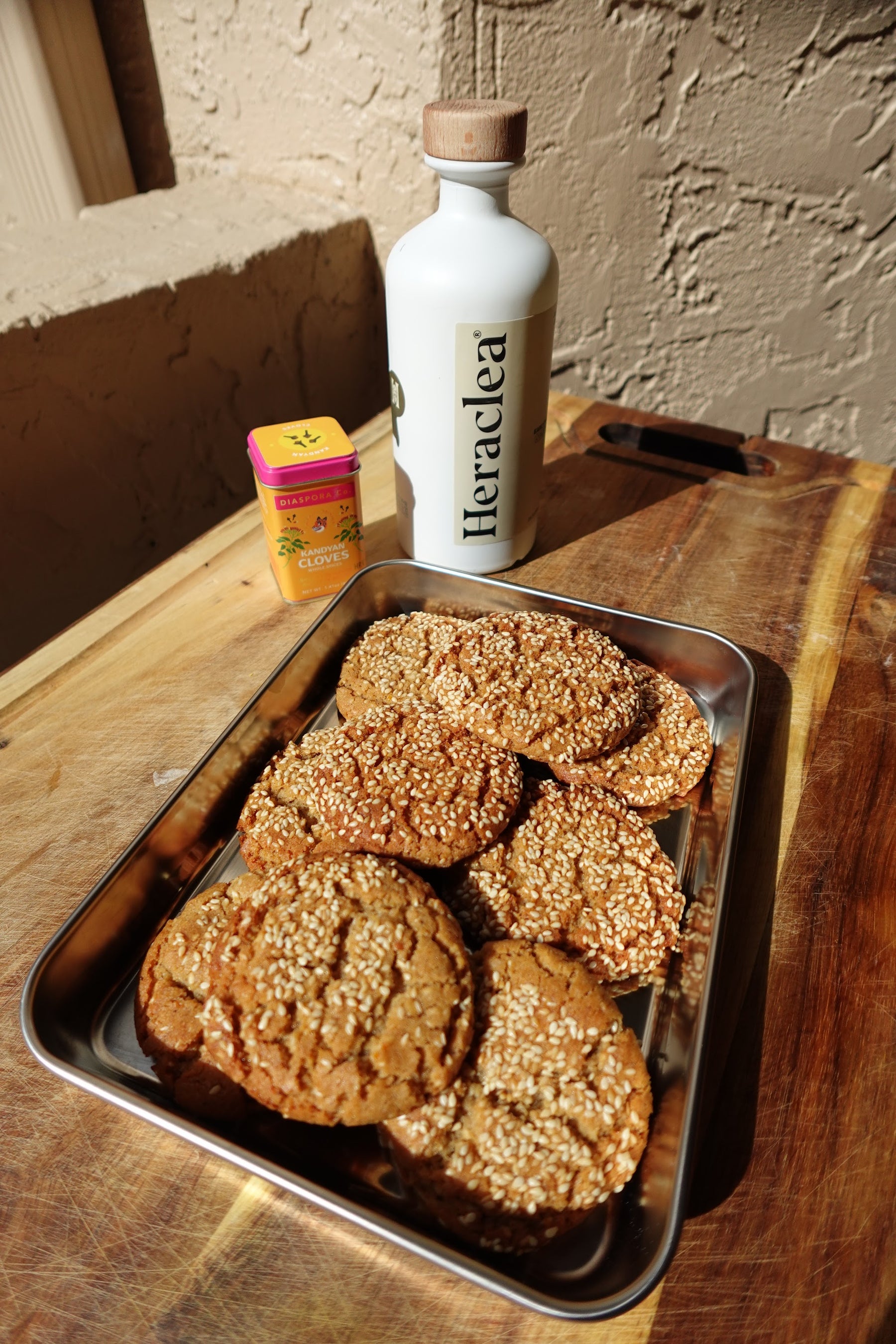 Spiced honey cookies rolled in toasted sesame seeds, made with tahini and Heraclea Early Harvest olive oil
