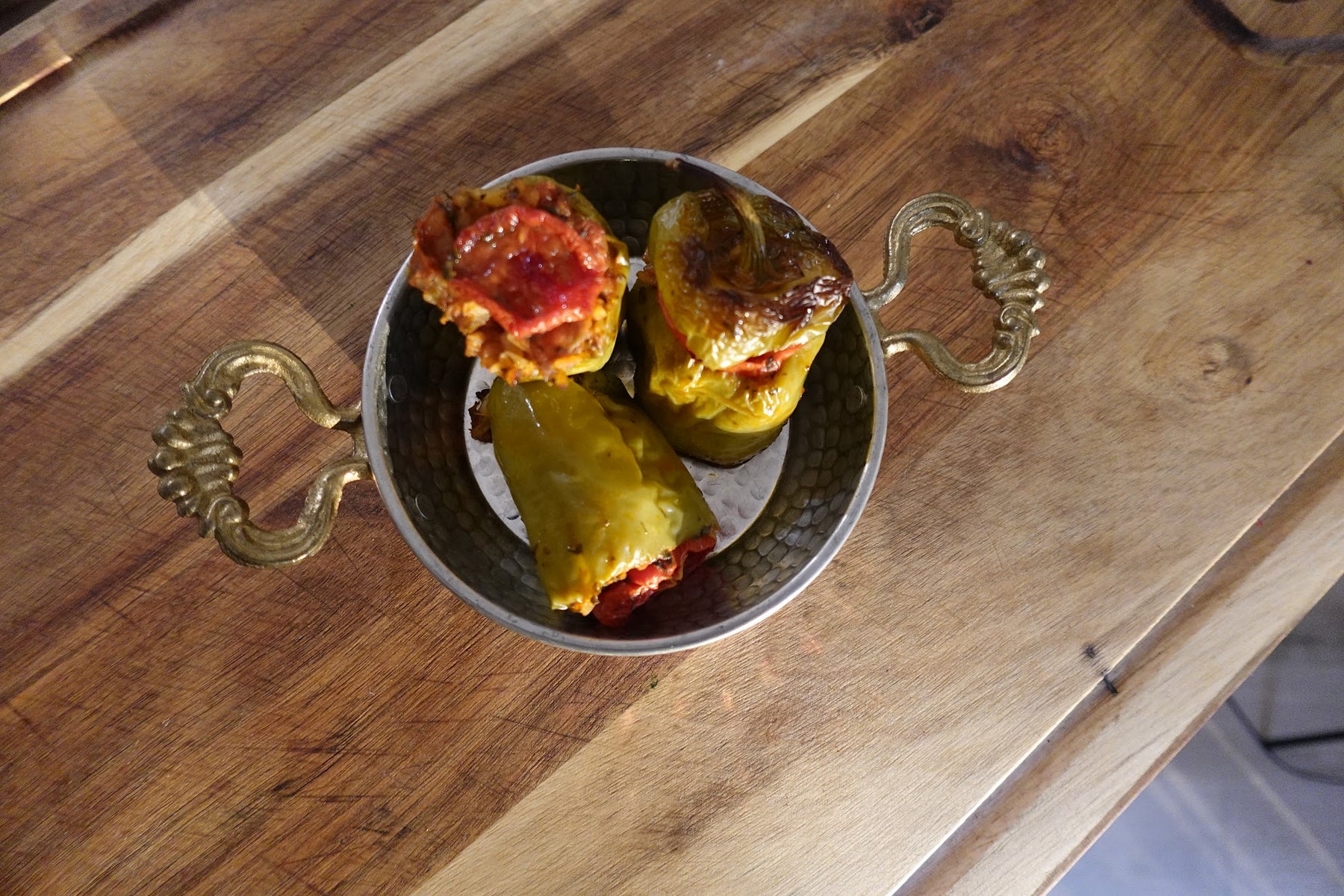 Turkish stuffed peppers (biber dolması) filled with herbed rice and baked in tomato sauce