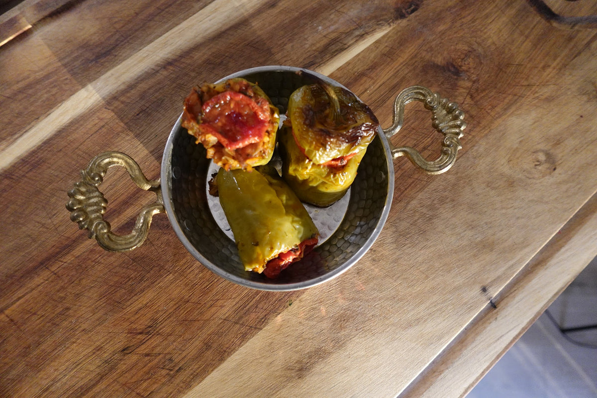Turkish stuffed peppers (biber dolması) filled with herbed rice and baked in tomato sauce
