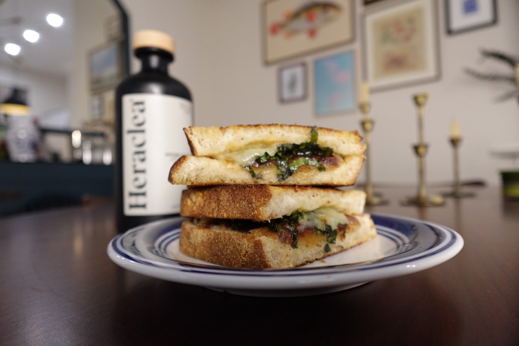 Gourmet grilled cheese with dates and olive oil confit garlic, sliced to show melted white cheddar on golden sourdough