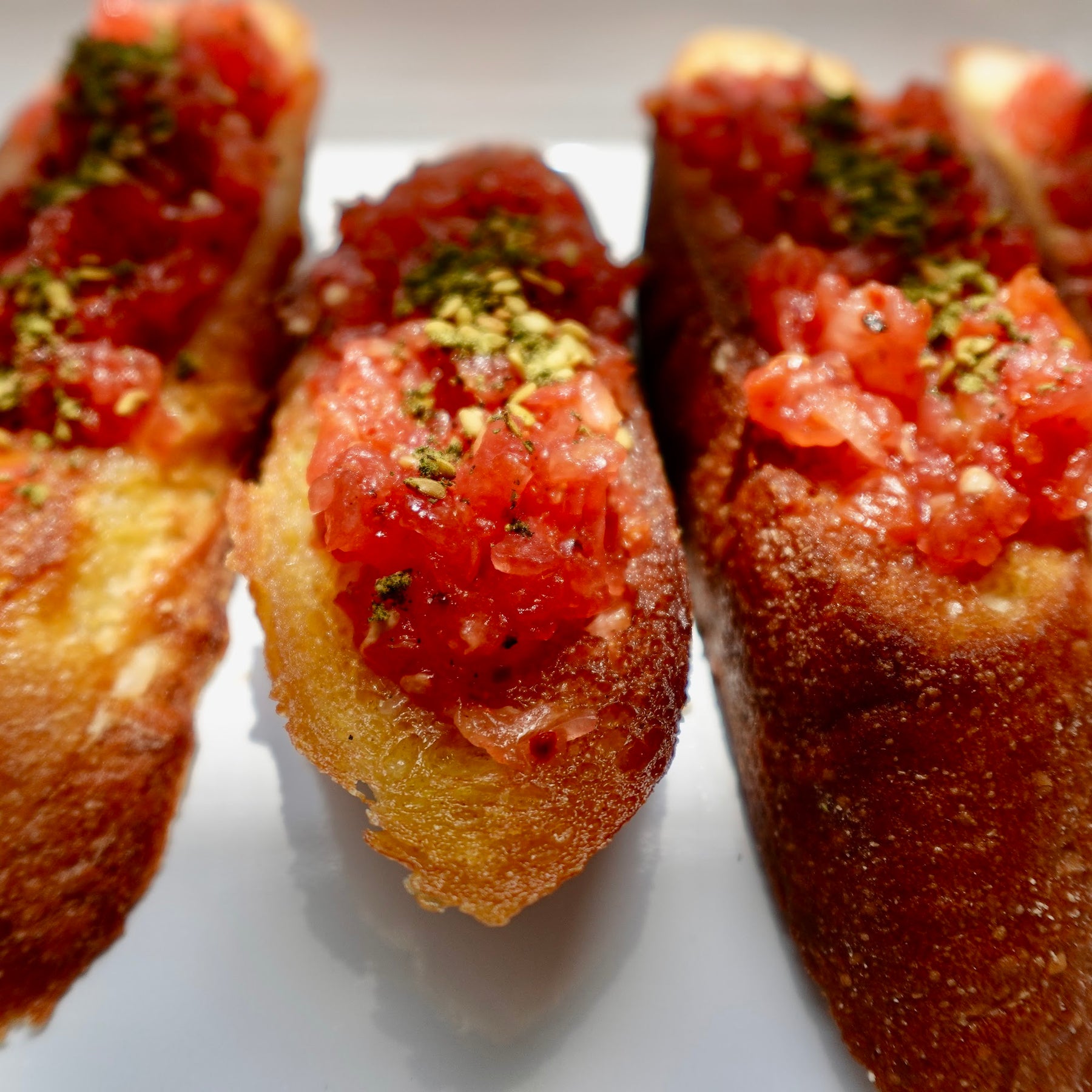Pan con tomate: grated summer tomato piled on garlic-rubbed toasted baguette, drizzled with olive oil.