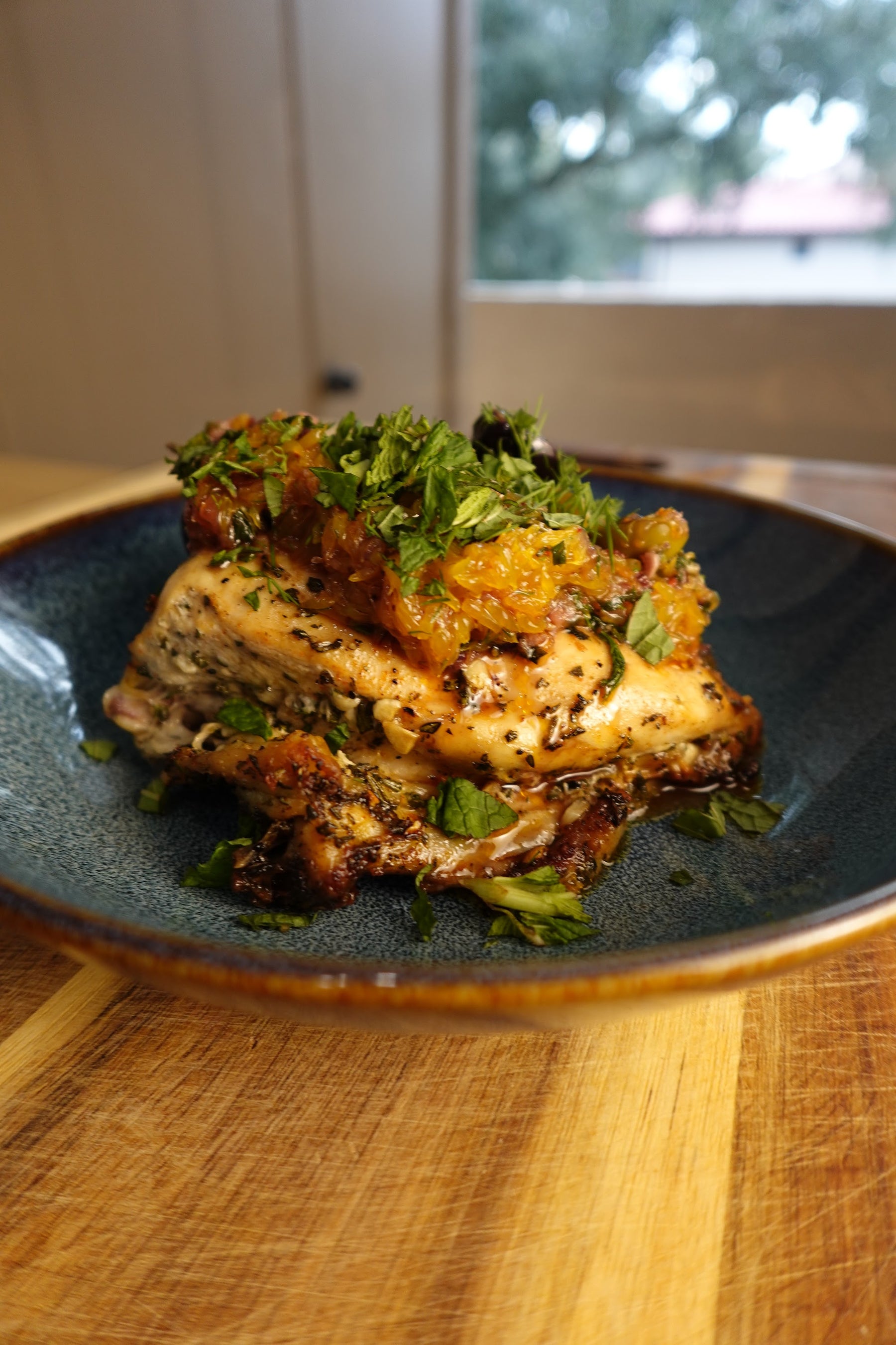 Turkish citrus chicken: roasted chicken thighs topped with warm Kalamata and Castelvetrano olives, orange segments, and fresh herbs