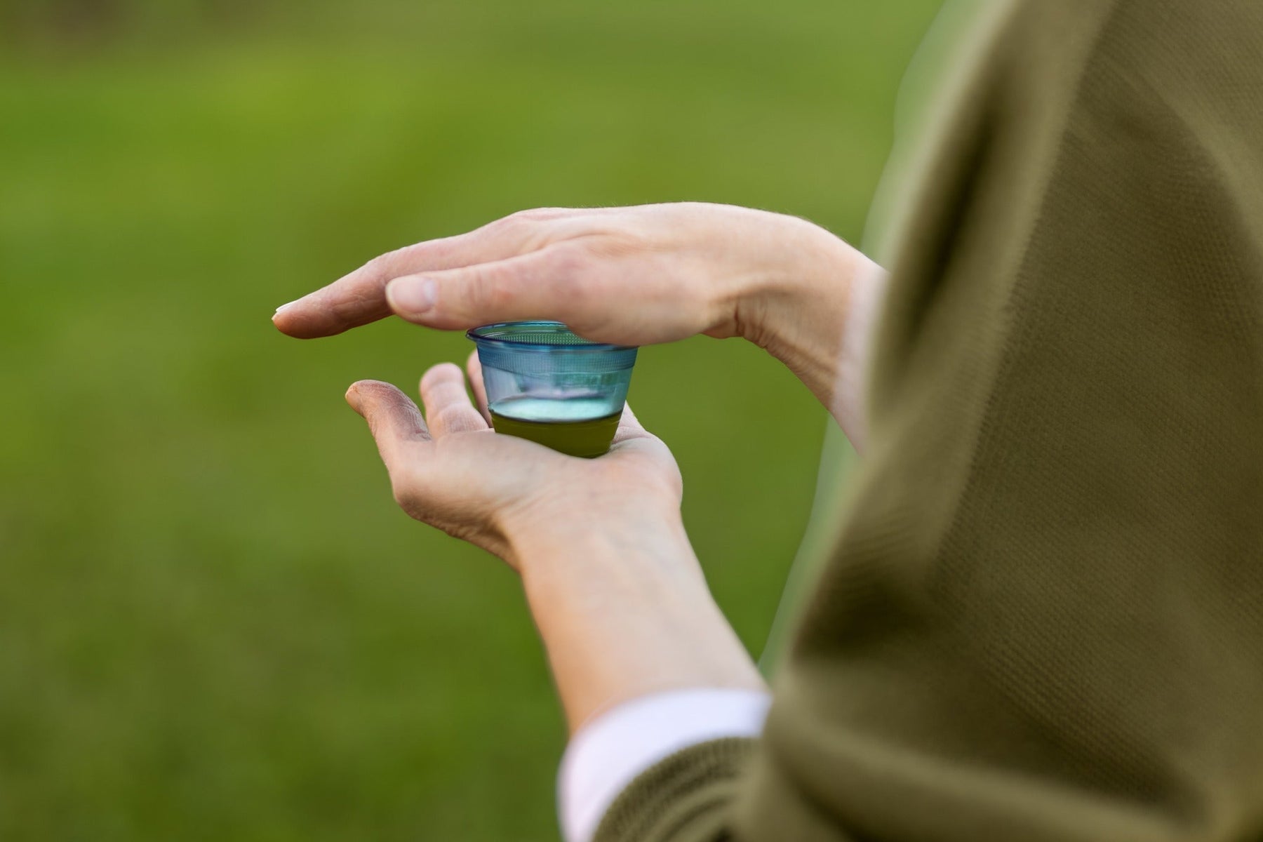 Spoonful of extra virgin olive oil being poured — the wellness shot trend has become a daily ritual, but the science is more boring (and more useful) than the trend suggests